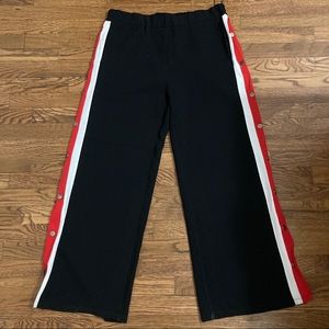 Black, red, and white snap-button pants